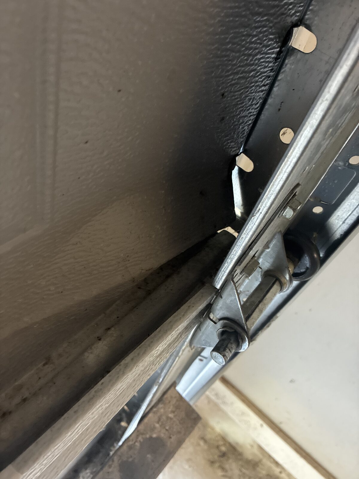 Garage door hanging with tension on the door sections, hinges, and roller hardware in Decatur, Georgia