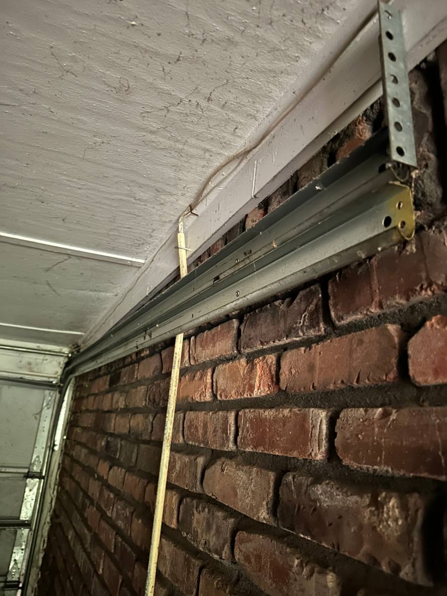 Straight, undamaged horizontal garage door track inspected and kept during the panel replacement in Decatur GA