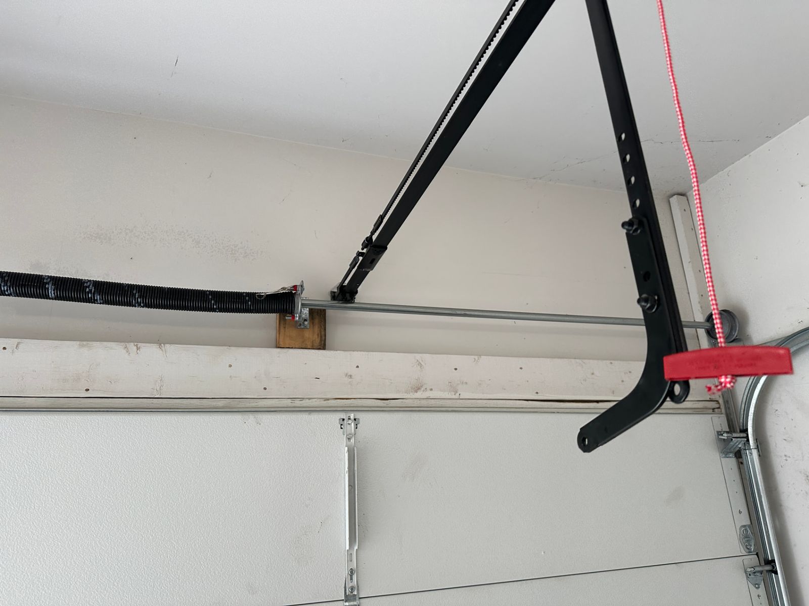 Garage door opener rail and torsion spring assembly that was not securely mounted to the wall header in Suwanee, Georgia