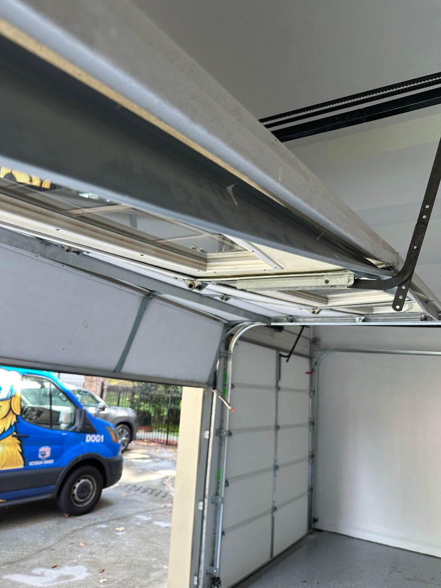 Full view of the severely damaged garage door showing it is beyond repair and needs a full replacement in Atlanta, Georgia