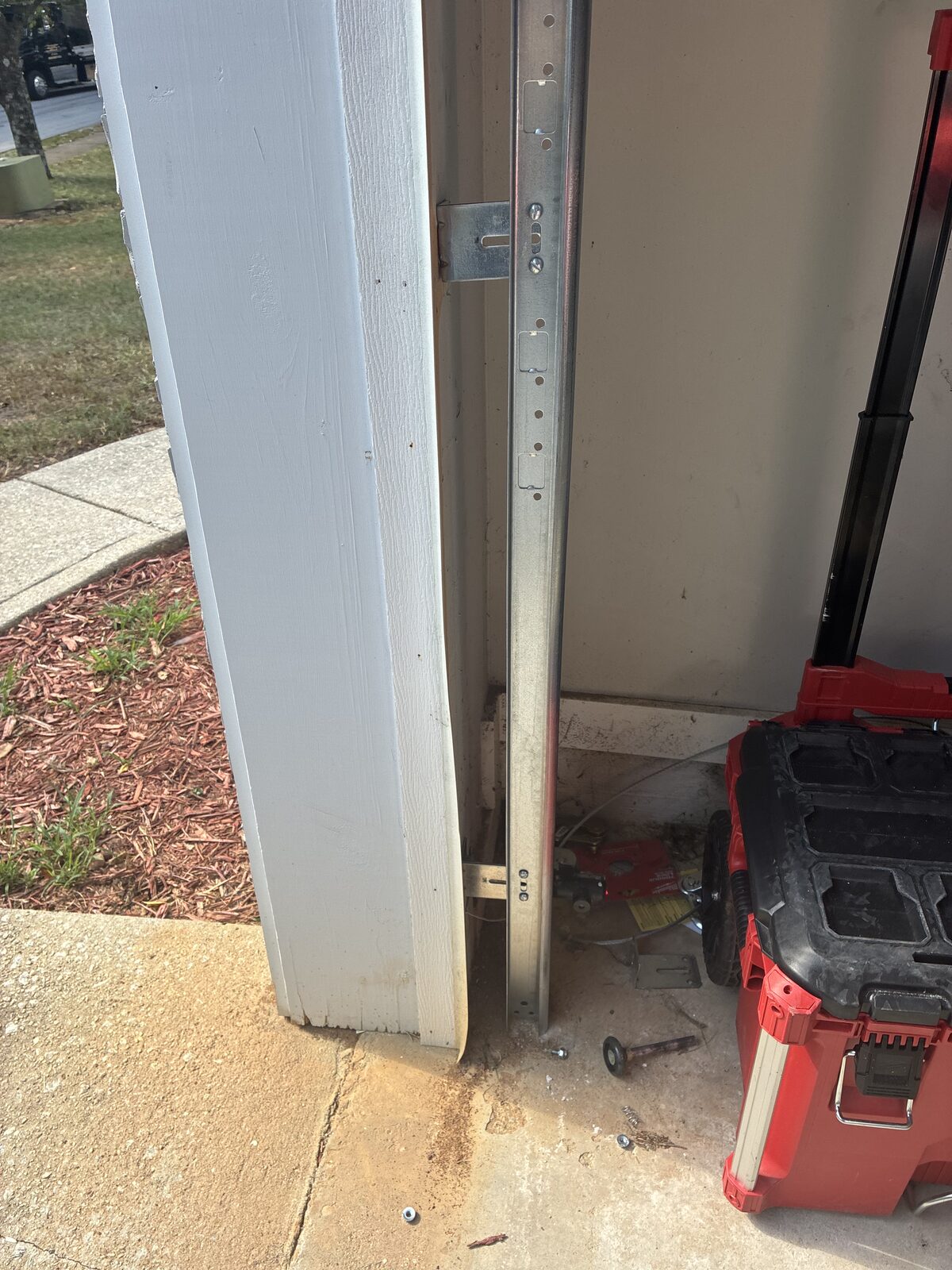 Garage door repaired and back on its track with a new vertical track installed after cable and track replacement in Decatur, Georgia