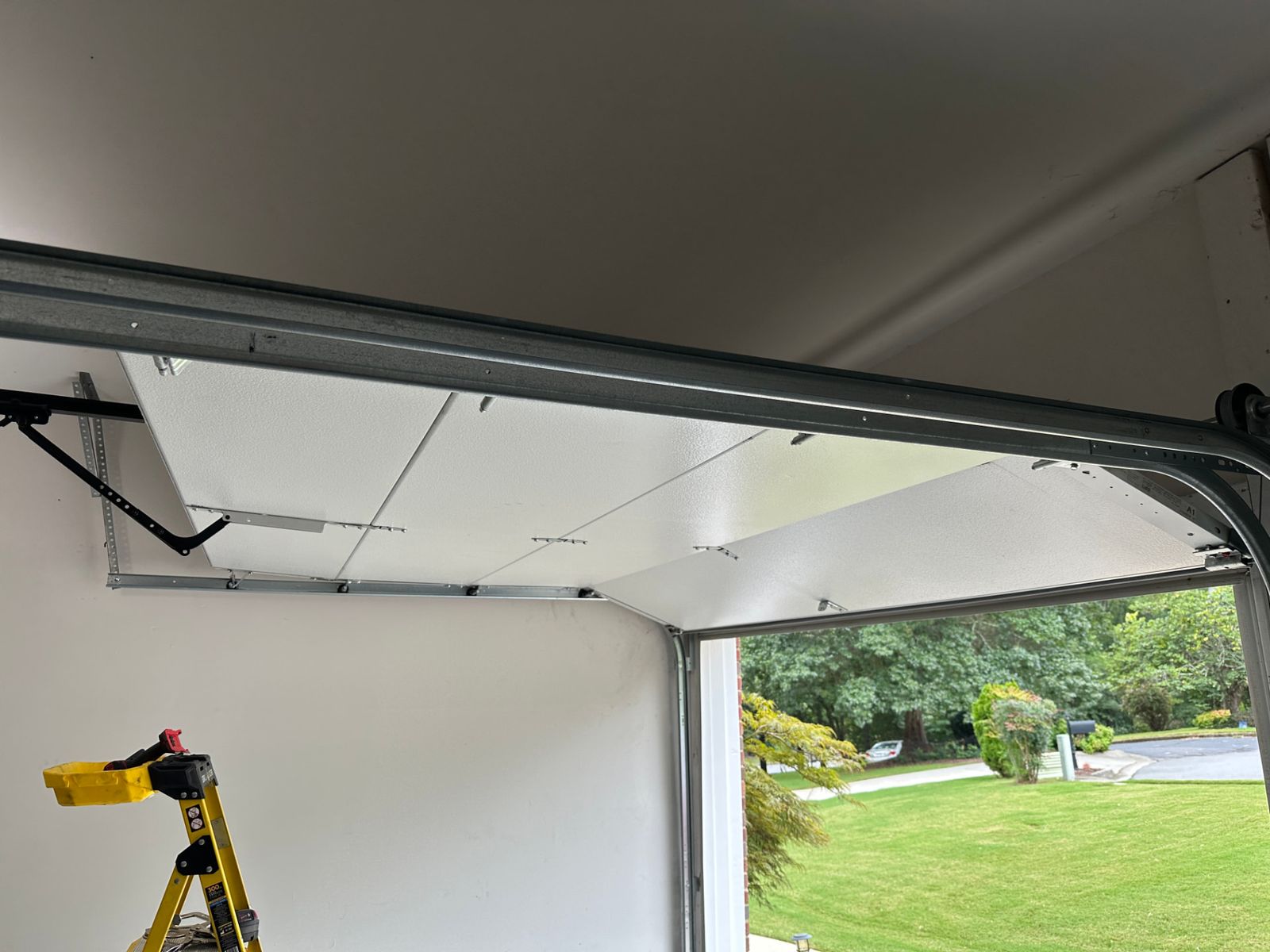 Garage door opener rail properly fastened and secured to the wall header after repair in Suwanee, Georgia