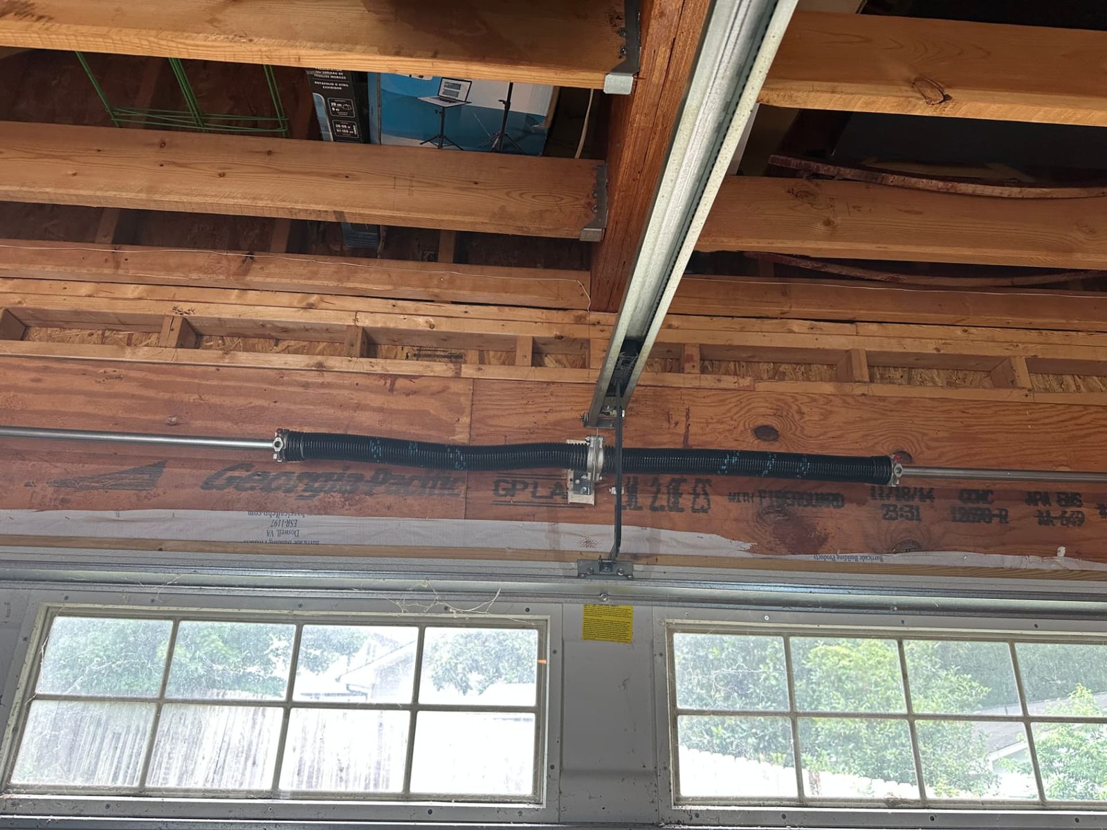 Newly installed dual torsion spring system on a converted garage door in the Kirkwood Oakhurst area of Atlanta
