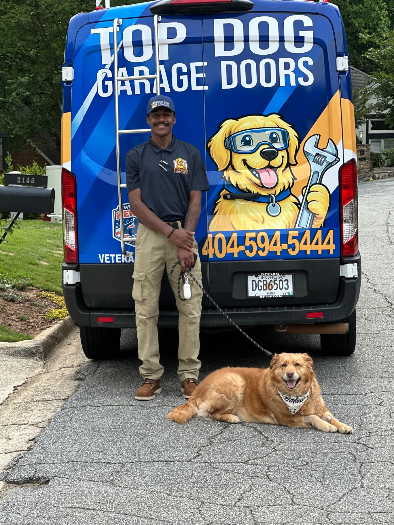 Top Dog Garage Doors technician and mascot dog outside a Decatur, GA home